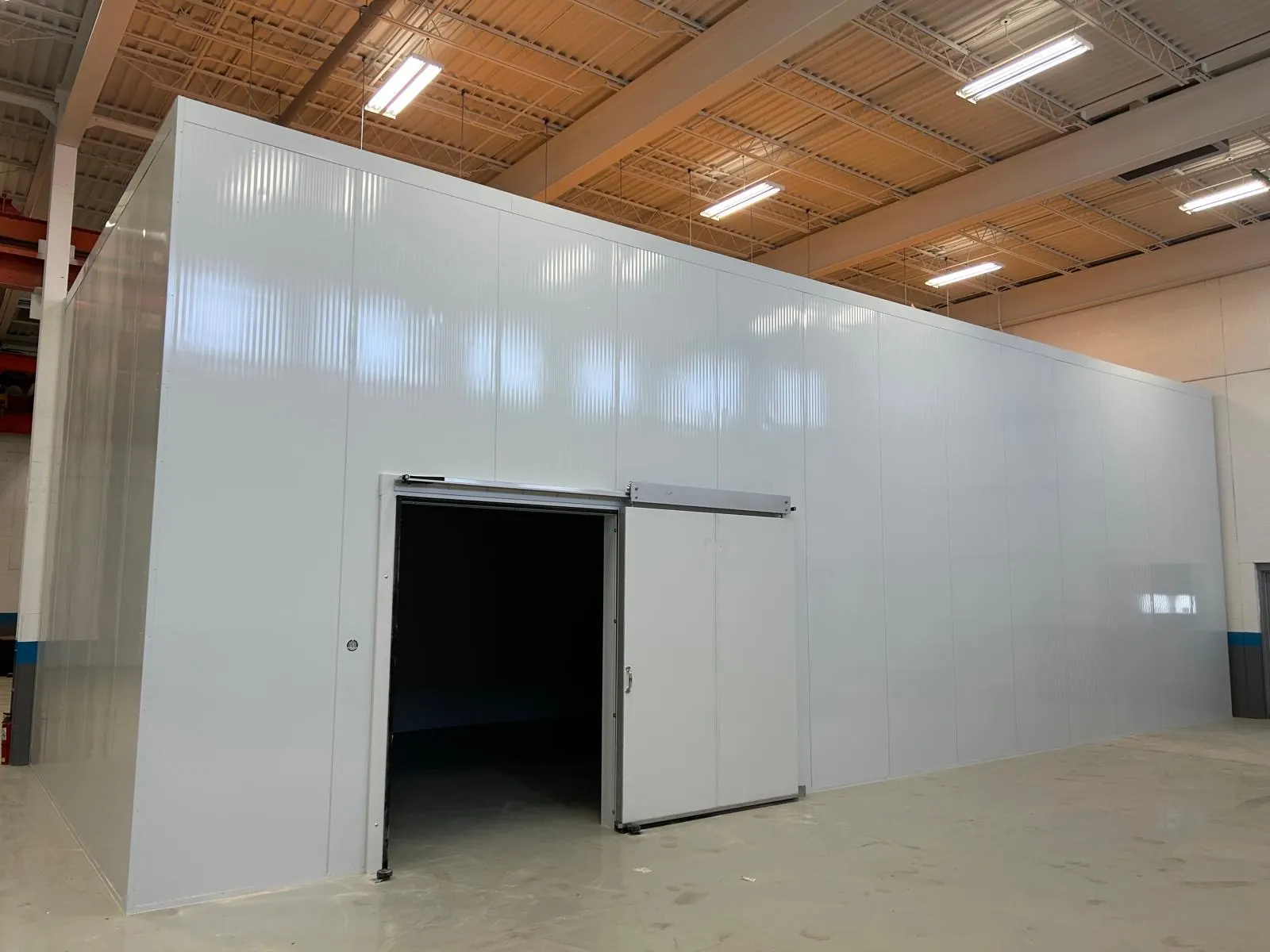 Insulated panel cold room with a sliding door, built by IB Technical