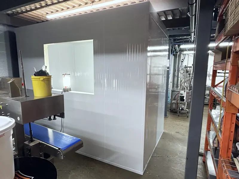 Freestanding walk-in room with a viewing window built inside a food production facility